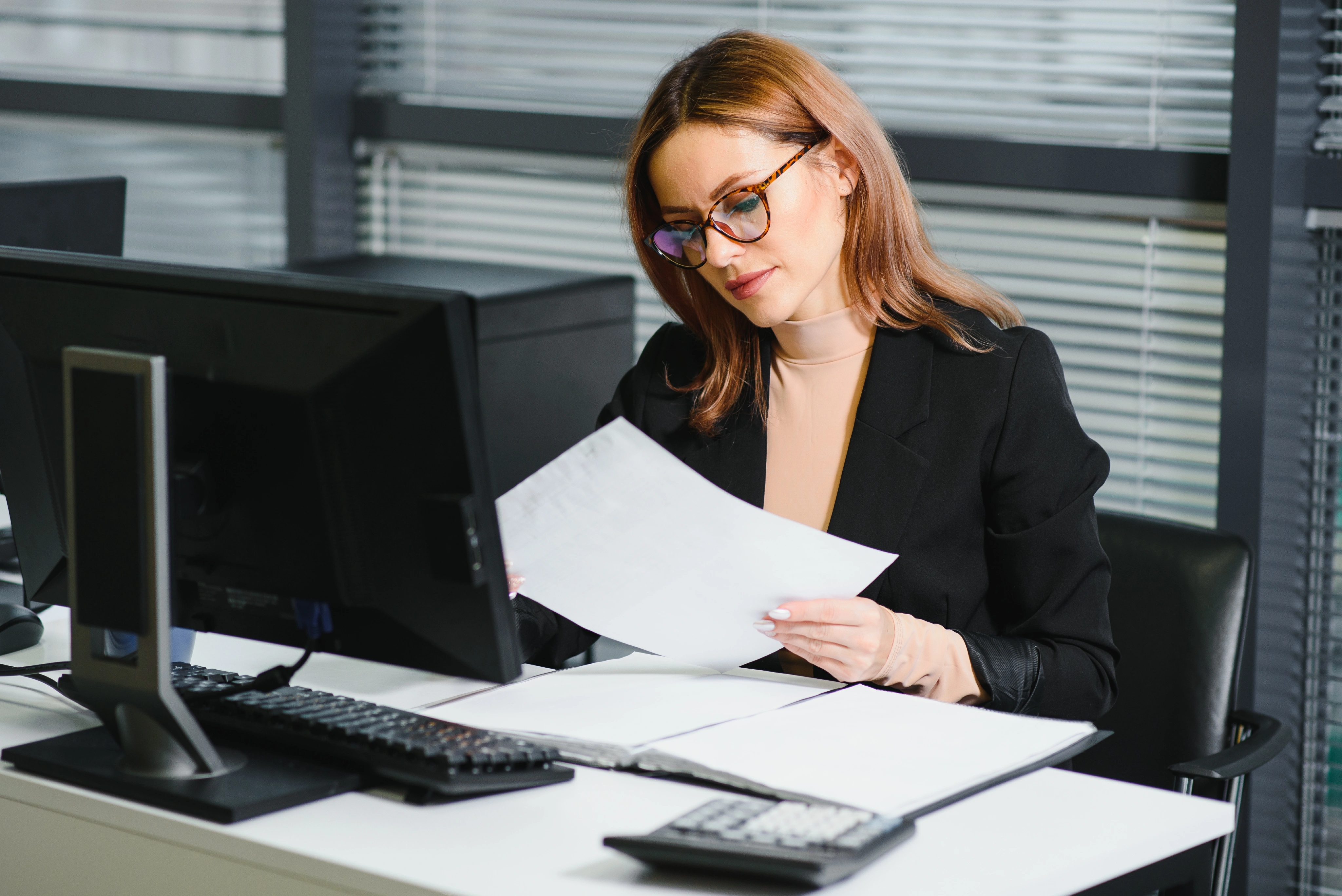 Tax Advisor reviewing client plans on laptop