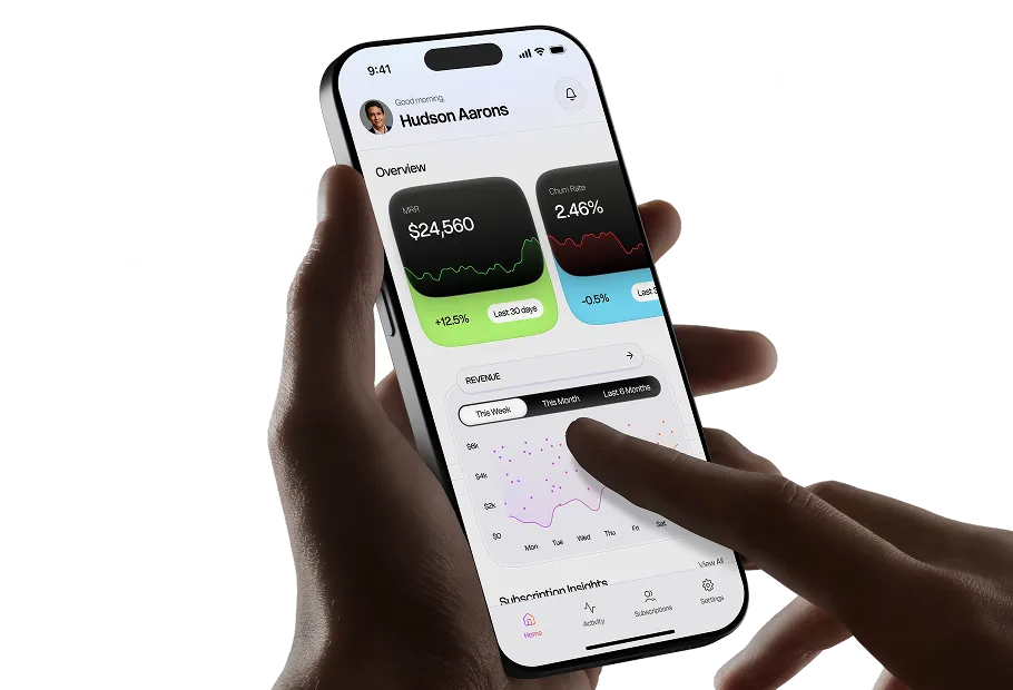 Hand holding a smartphone showing a finance app dashboard, with React logo outlines in the background
